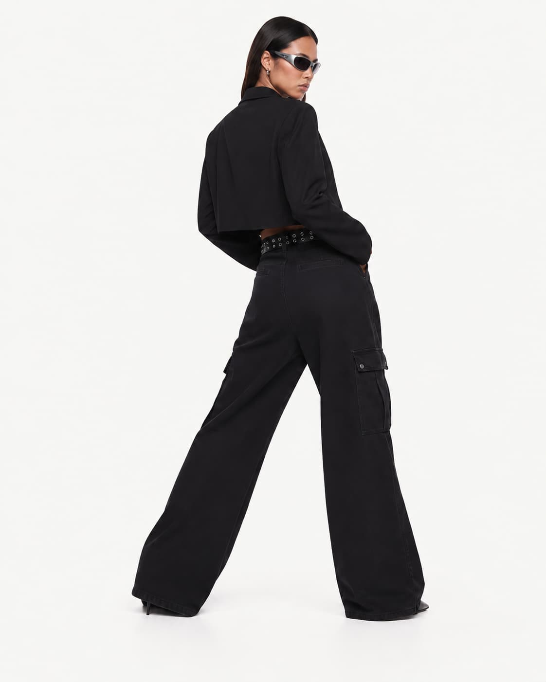 Back view — the cropped blazer's shoulder line and the cargo trousers' rear pockets.
