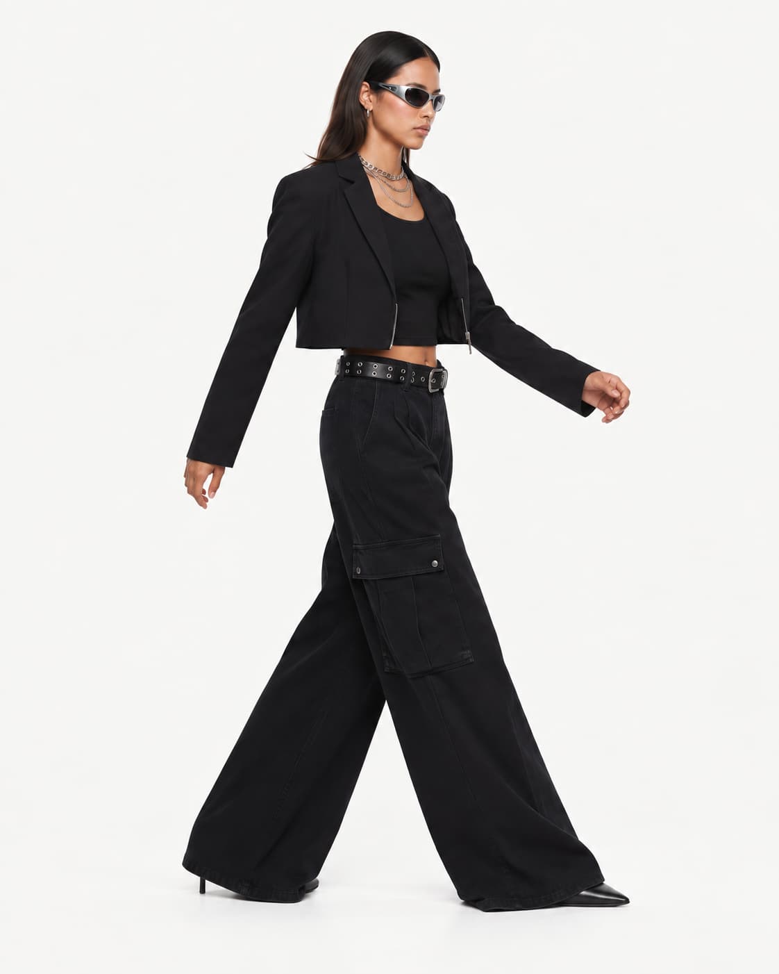 Side view — the same look mid-stride, showing the trousers' drape in profile.