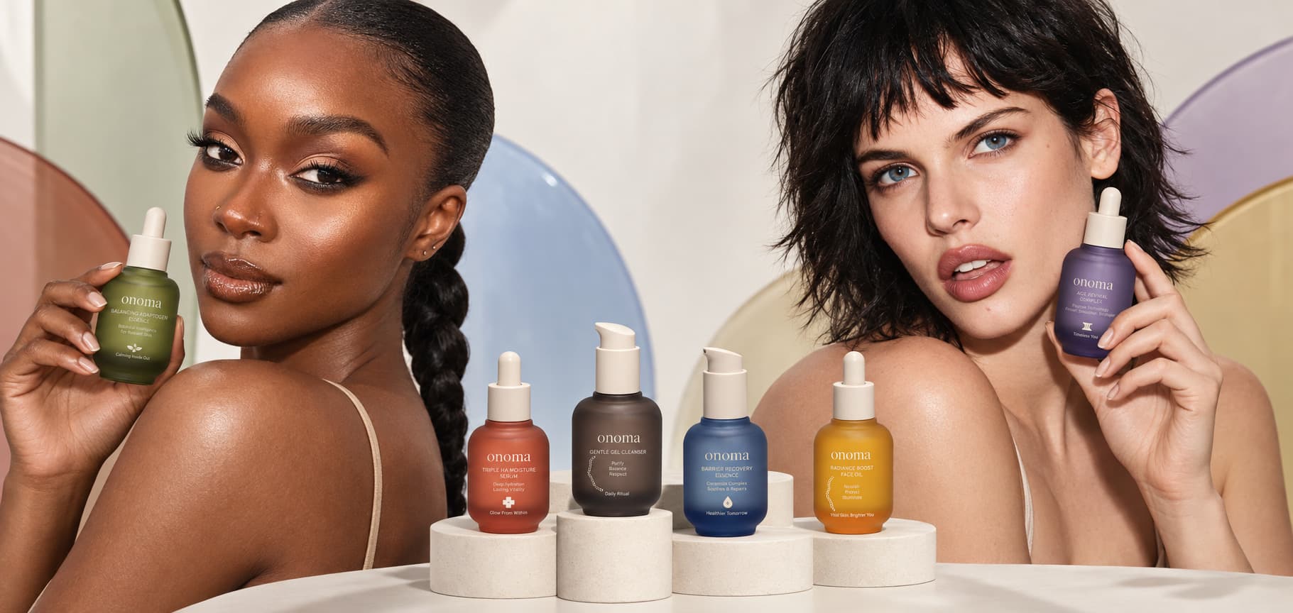 Onoma campaign lead — two models holding the green adaptogen essence and the purple age-revival complex, with the six-bottle range on plinths between them.